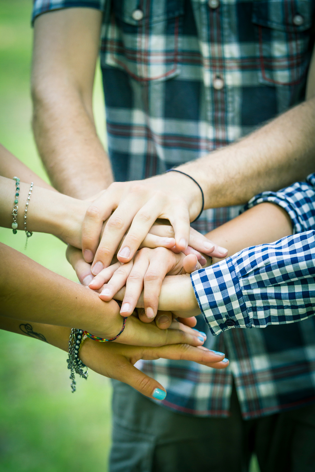 Group of friends joining hands